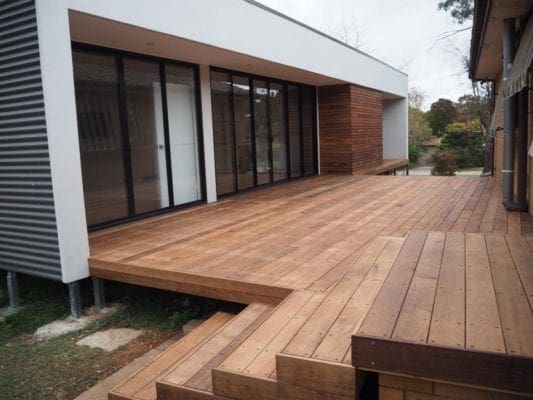 Spacious flat with wooden floors and stairs, glass doors and windows.